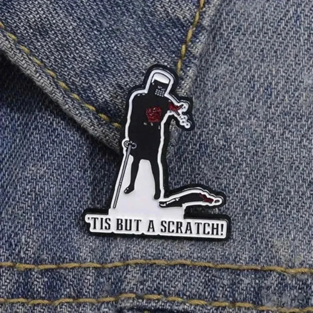 Man in black cut off arm ‘Tis but a scratch enamel brooch pin denim bag clothes